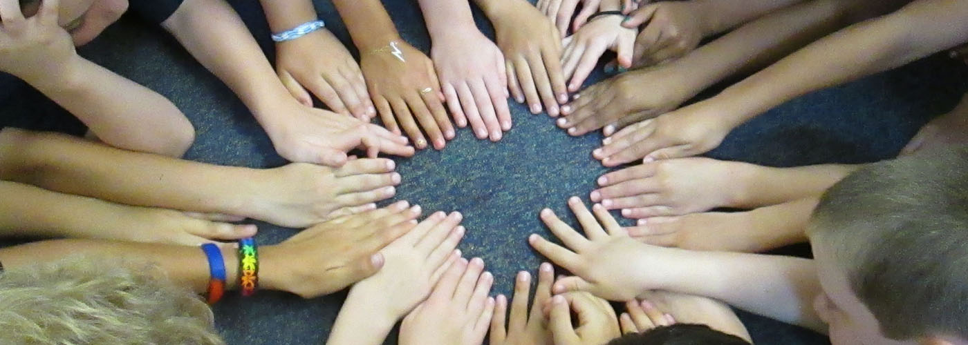 Bates Community Building Students Hands Together in a Circle