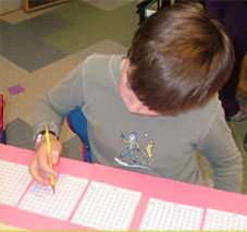 student working on math at a table